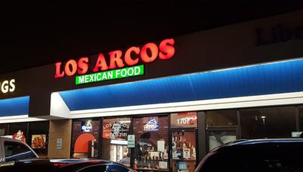 Los Arcos storefront at night with its red neon sign on Algonquin Road